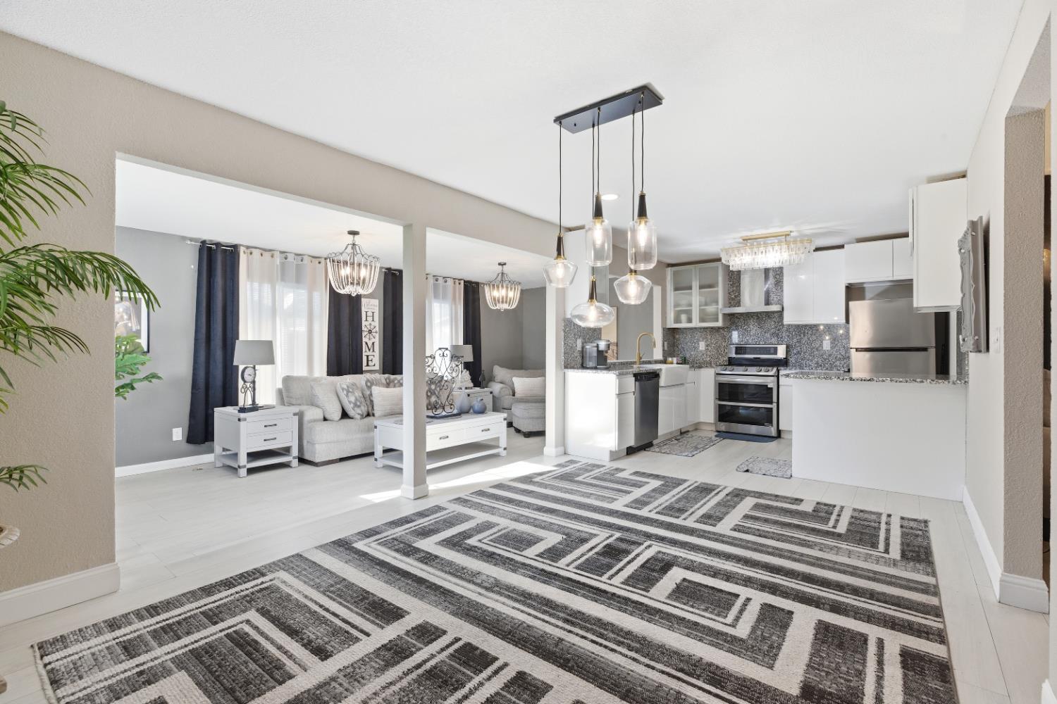 3713 Felkirk Way Modesto, CA 95356 - Photo 5 of 16 a living room with lots of furniture and kitchen view