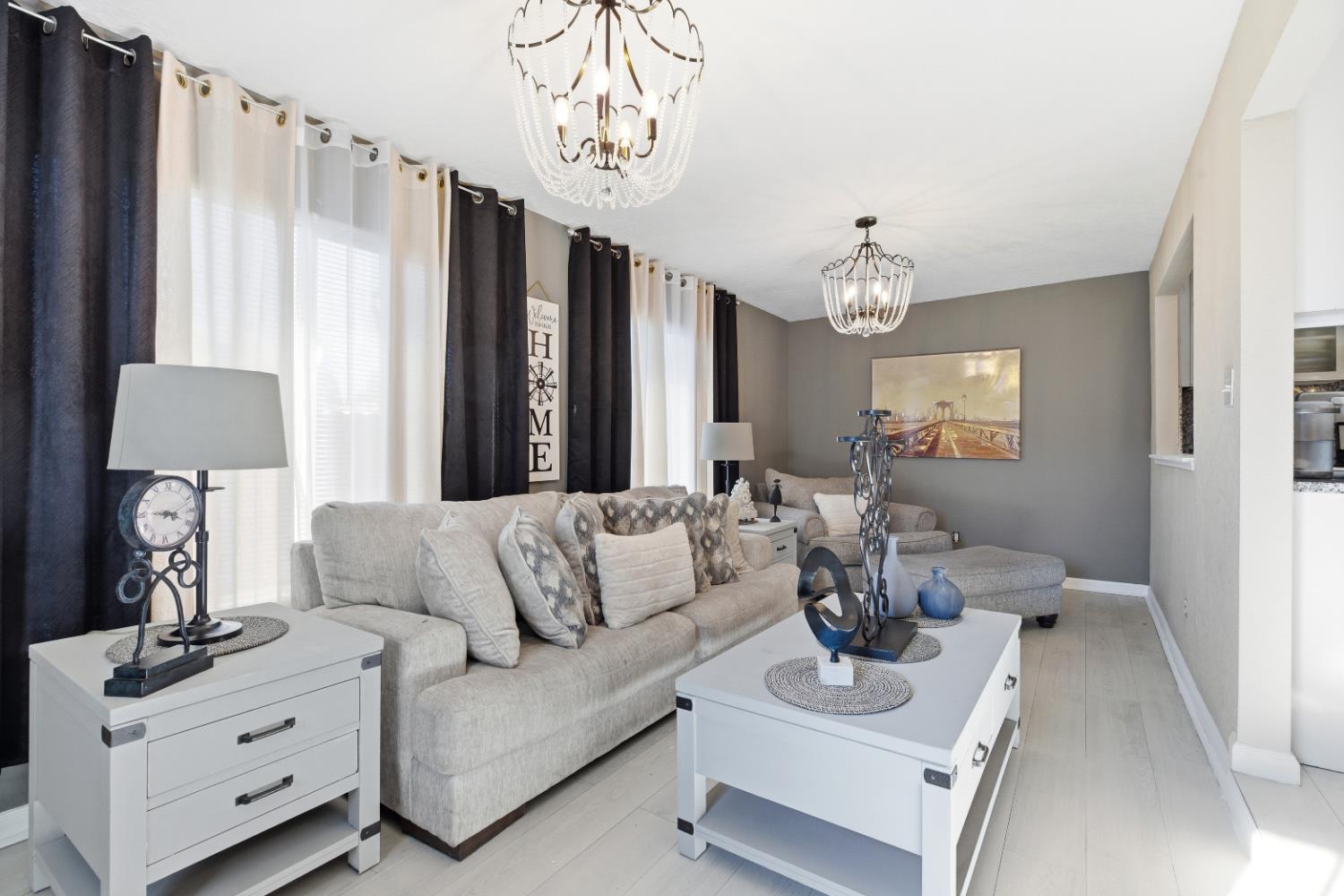 3713 Felkirk Way Modesto, CA 95356 - Photo 6 of 16 a living room with furniture and a chandelier