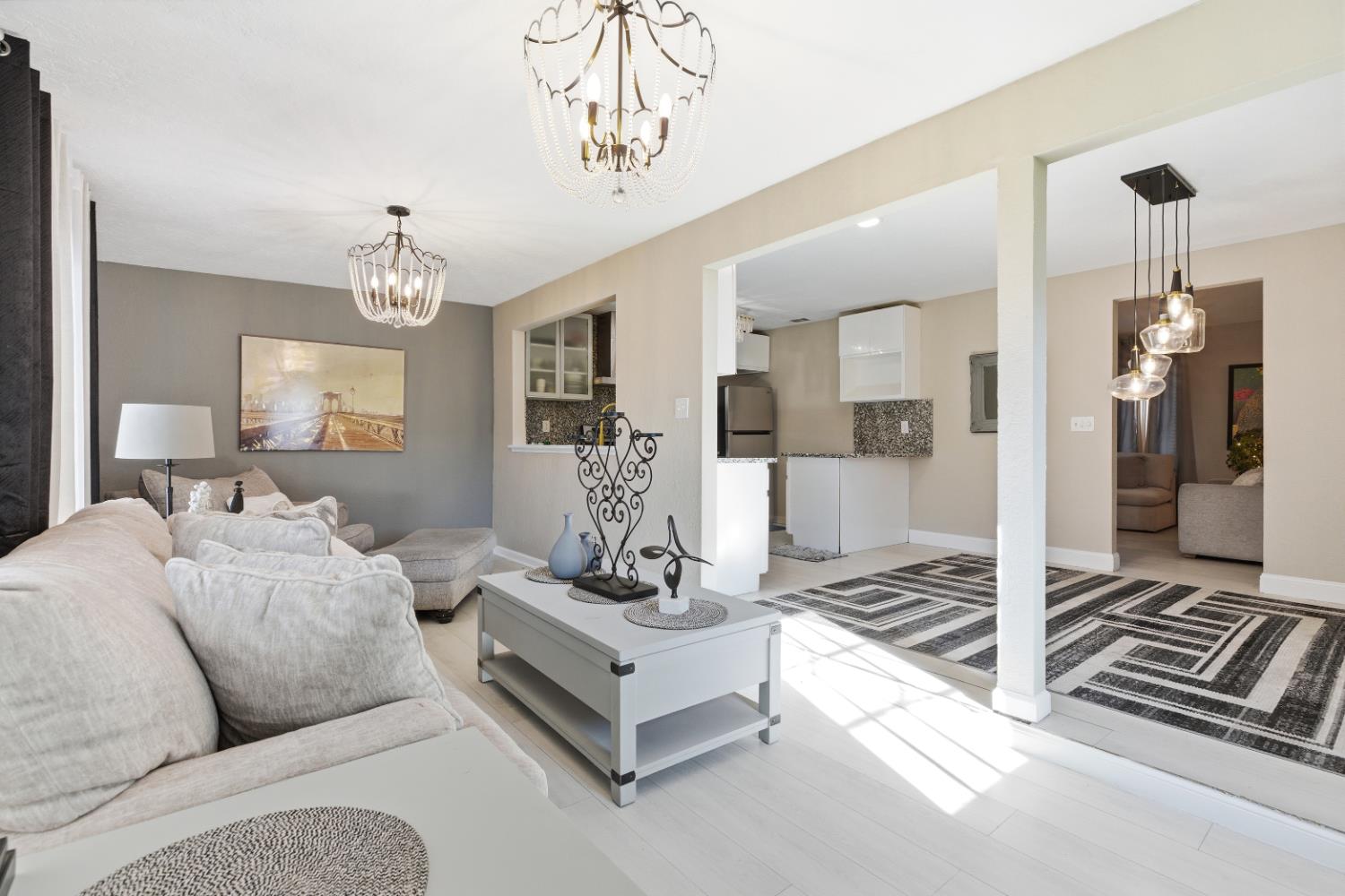 3713 Felkirk Way Modesto, CA 95356 - Photo 7 of 16 a living room with furniture and a chandelier