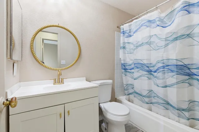 a bathroom with a sink a toilet and a mirror