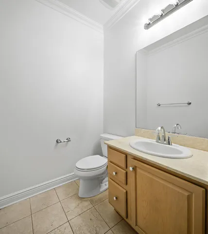 a bathroom with a granite countertop toilet a sink and a mirror