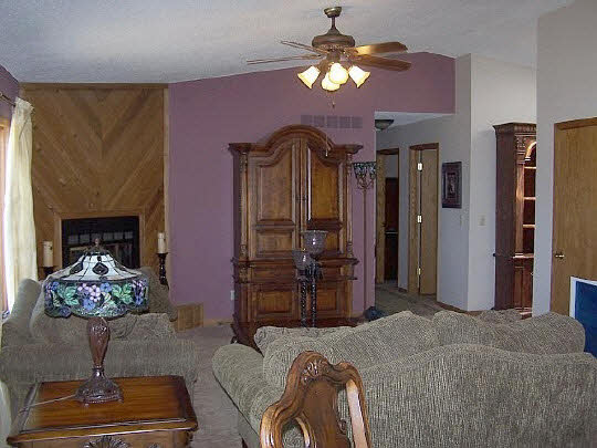 3605 Cutty Sark Road Cherry Valley, IL 61016 - Photo 5 of 11 a spacious bedroom with a bed dresser and a fireplace