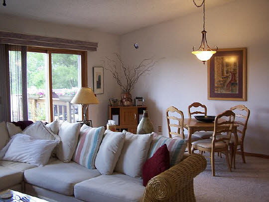 3605 Cutty Sark Road Cherry Valley, IL 61016 - Photo 8 of 11 a living room with furniture a large window and a chandelier