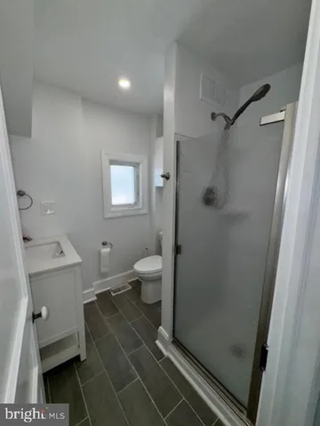 a bathroom with a toilet and a shower