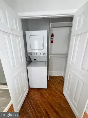 a view of storage and utility room with wooden floor