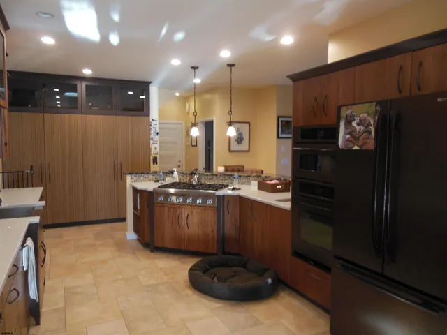 a kitchen with sink cabinets and refrigerator