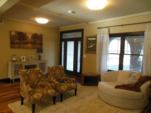 a living room with furniture and a chandelier