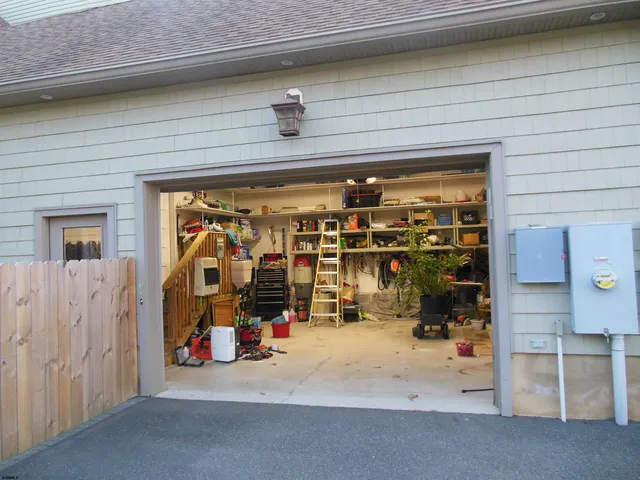 a dining room with furniture and a floor to ceiling window