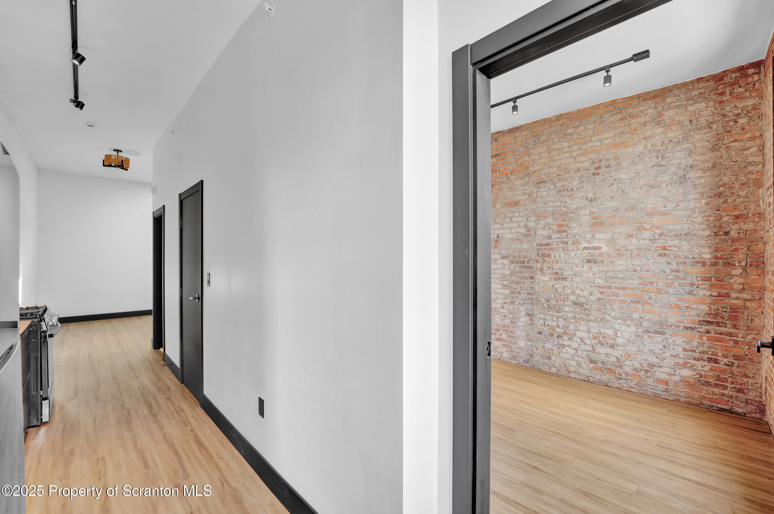 115 Penn Avenue, Unit 303 Scranton, PA 18503 - Photo 46 of 60 a view of a hallway with wooden floor