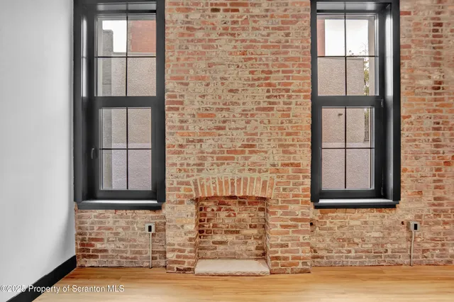 a living room with fireplace furniture and a window