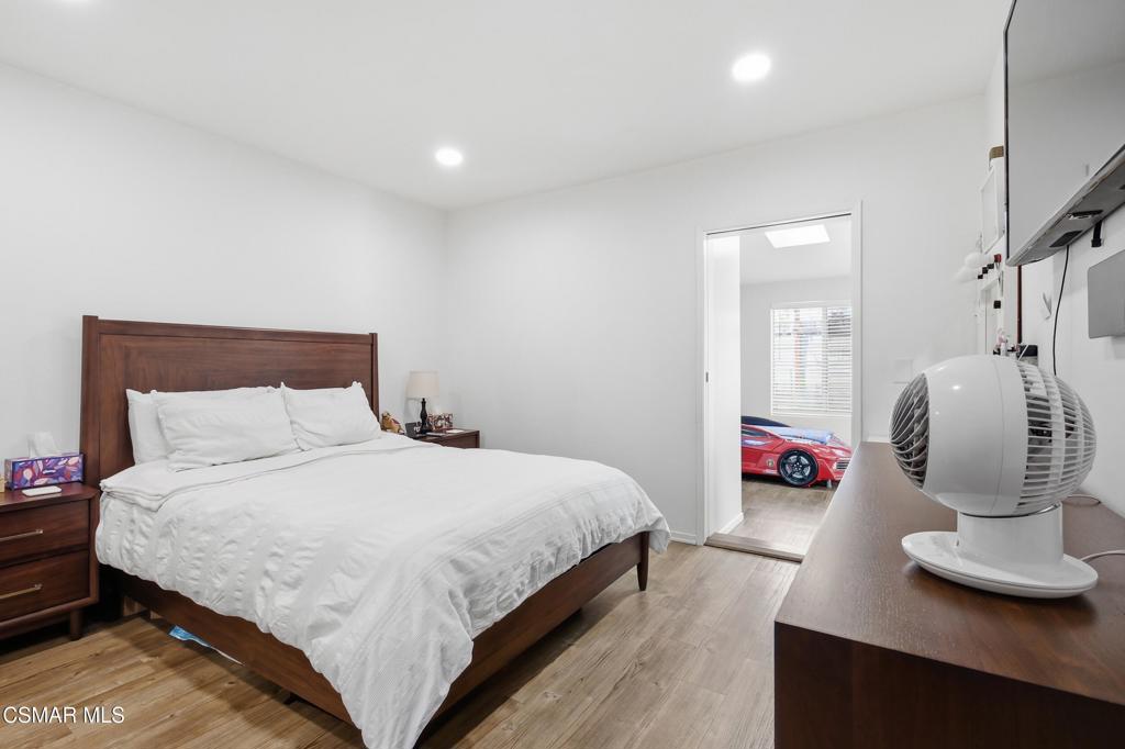 1485 Sequoia Avenue Simi Valley, CA 93063 - Photo 14 of 20 a bedroom with a bed and wooden floor