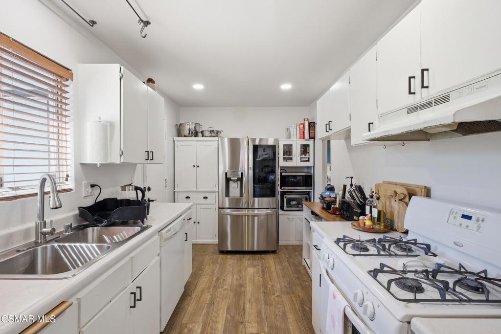 1485 Sequoia Avenue Simi Valley, CA 93063 - Photo 6 of 20 a kitchen with refrigerator a stove and cabinets