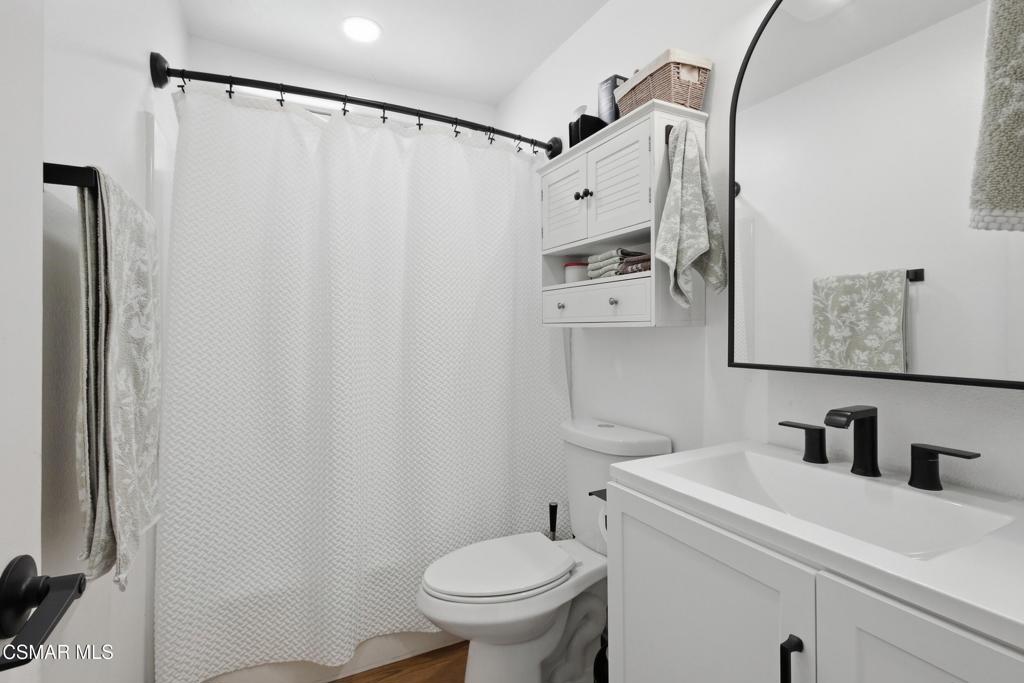 1485 Sequoia Avenue Simi Valley, CA 93063 - Photo 9 of 20 a bathroom with a sink a toilet and shower curtain