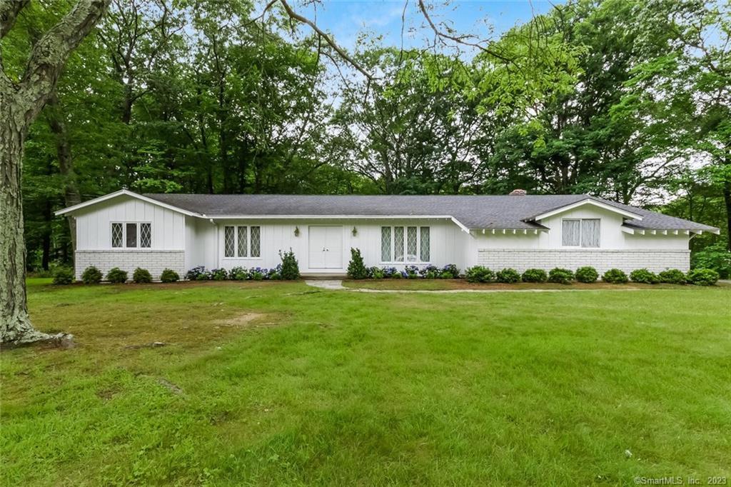 a front view of house with yard and green space
