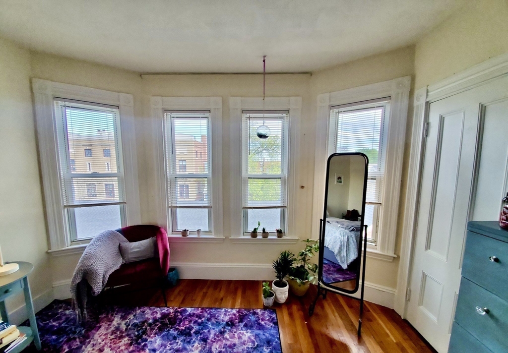 a bed room with a bed mirror and a window