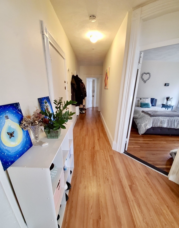 40 Forest Street, Unit 3 Boston, MA 02119 - Photo 12 of 20 a room with wooden floor and furniture