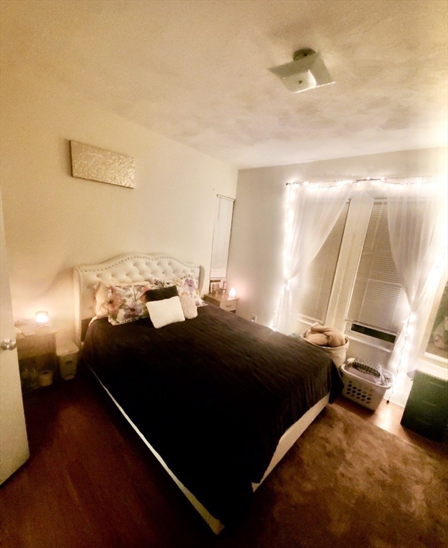 40 Forest Street, Unit 3 Boston, MA 02119 - Photo 13 of 20 a bedroom with a bed and a night stand