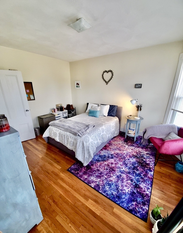 40 Forest Street, Unit 3 Boston, MA 02119 - Photo 15 of 20 a bedroom with two bed and a large window