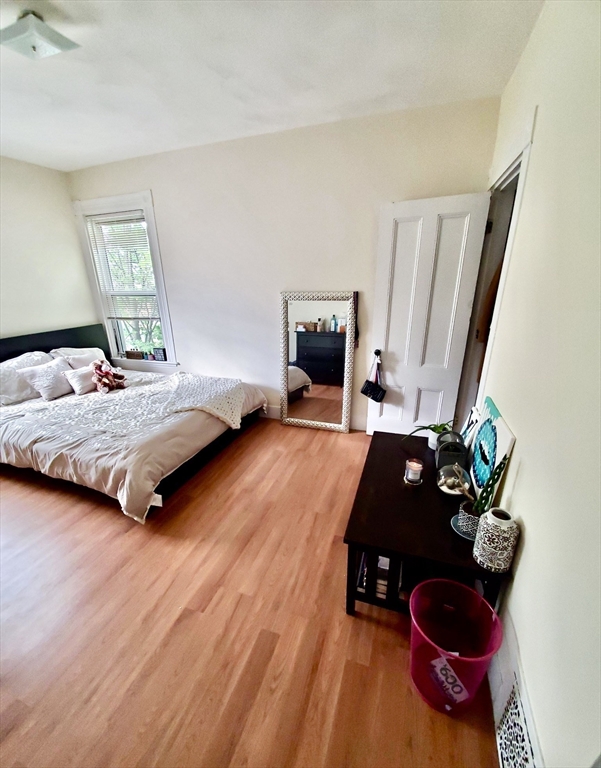 40 Forest Street, Unit 3 Boston, MA 02119 - Photo 16 of 20 a bedroom with a bed dresser and a window