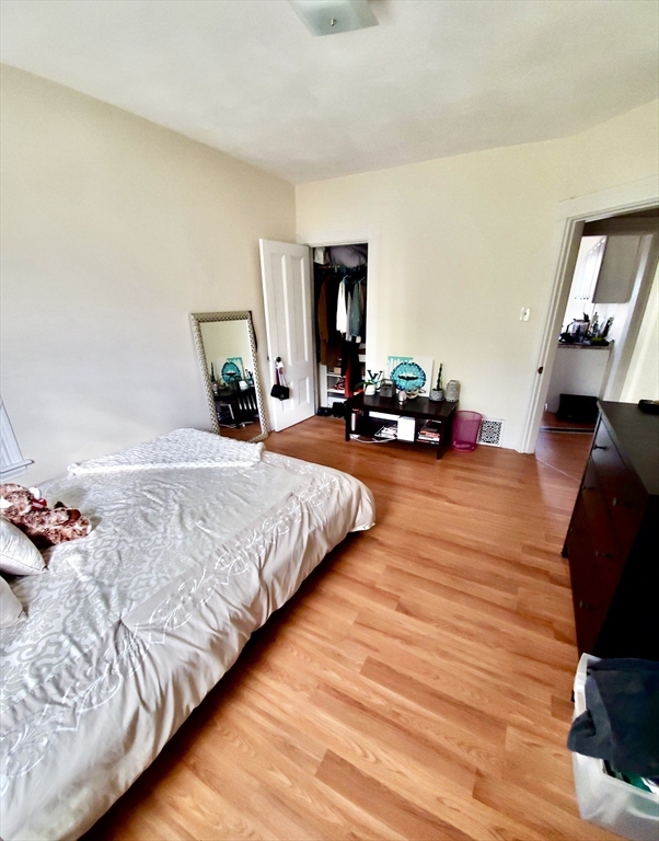 40 Forest Street, Unit 3 Boston, MA 02119 - Photo 19 of 20 a bed room with a bed window and a couch