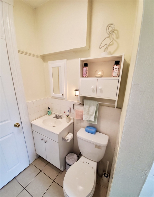 40 Forest Street, Unit 3 Boston, MA 02119 - Photo 20 of 20 a bathroom with a sink toilet and mirror