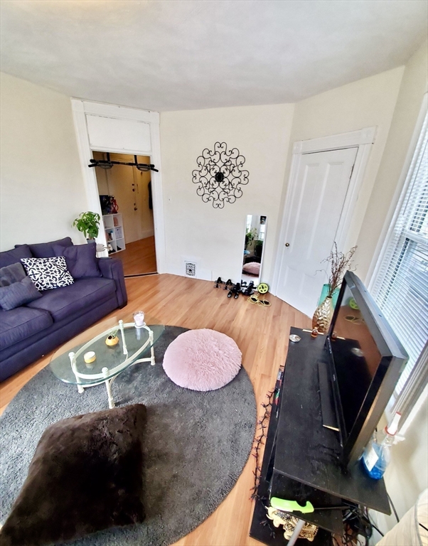 40 Forest Street, Unit 3 Boston, MA 02119 - Photo 2 of 20 a living room with furniture and a fireplace