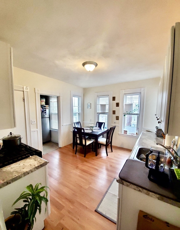 40 Forest Street, Unit 3 Boston, MA 02119 - Photo 3 of 20 a living room with furniture and wooden floor
