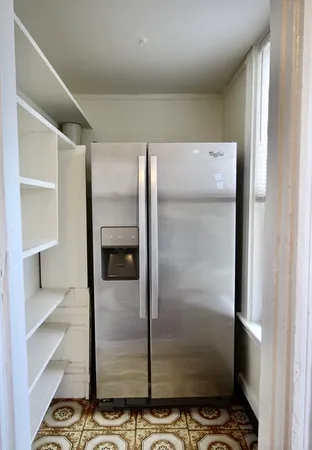 a view of a refrigerator in kitchen
