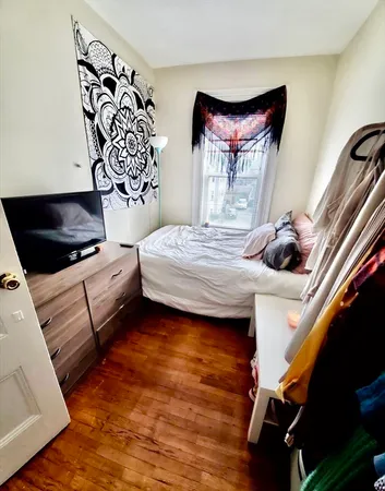 a bedroom with a bed and window