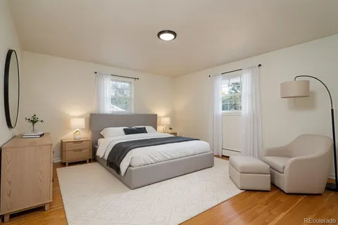 a bedroom with a bed couch and a window