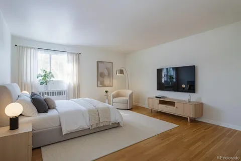 a bedroom with two beds and a flat screen tv