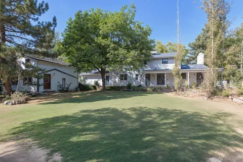 a front view of a house with swimming pool having outdoor seating