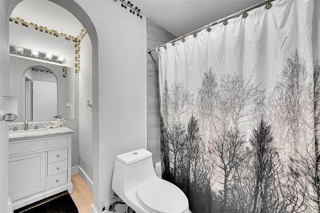 a bathroom with a toilet a sink and a mirror