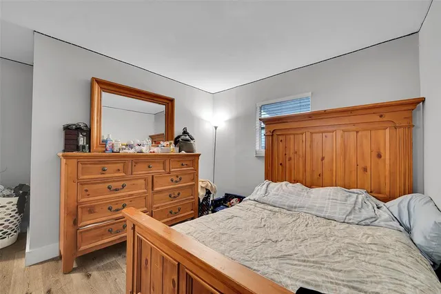 a bedroom with a bed and a dresser