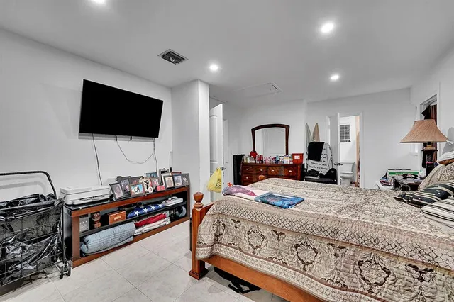 a bed room with a bed and a flat screen tv