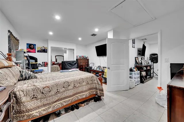 a bedroom with a bed and a tv