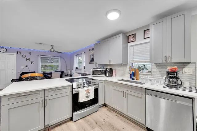 a kitchen with white cabinets and white appliances