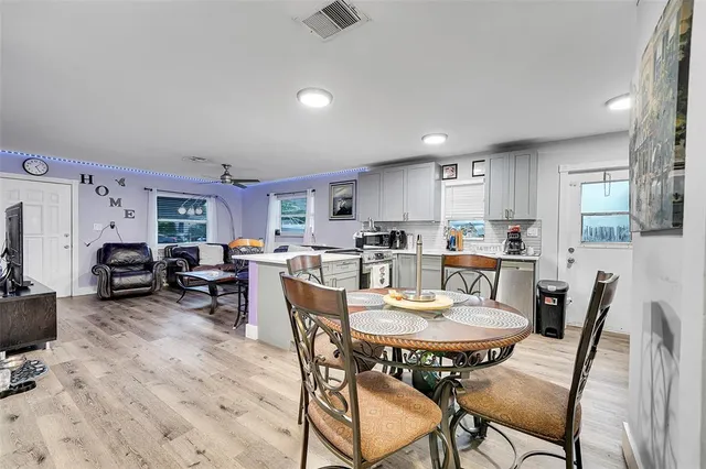 a view of a dining room with furniture and a kitchen