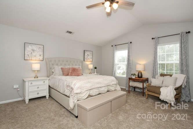 1431 River Run Road Lowell, NC 28098 - Photo 14 of 26 a spacious bedroom with a bed and a chandelier
