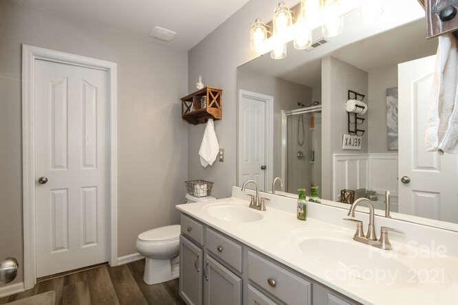 1431 River Run Road Lowell, NC 28098 - Photo 17 of 26 a bathroom with a sink vanity granite and toilet