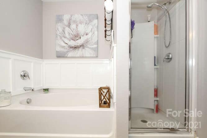 1431 River Run Road Lowell, NC 28098 - Photo 18 of 26 a bathroom with a bathtub and a shower