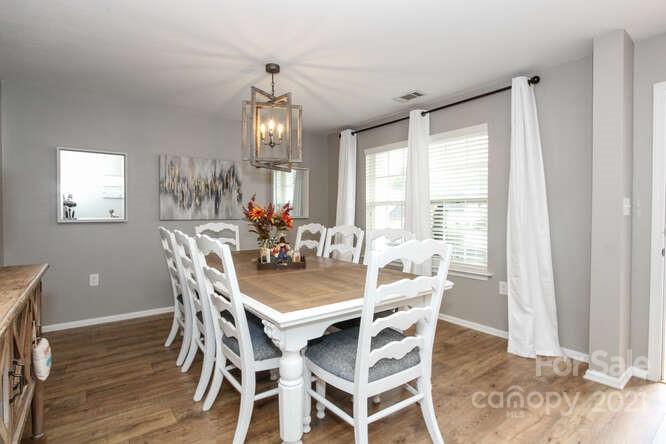 1431 River Run Road Lowell, NC 28098 - Photo 5 of 26 a view of a dining room with furniture window and wooden floor