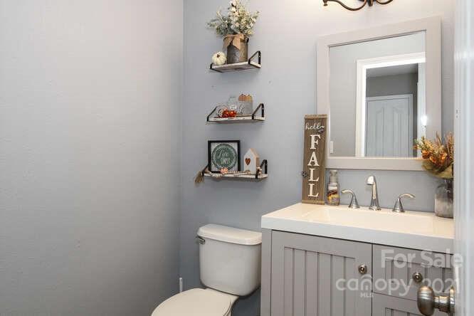 1431 River Run Road Lowell, NC 28098 - Photo 6 of 26 a bathroom with a toilet a sink and mirror
