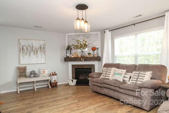 1431 River Run Road Lowell, NC 28098 - Photo 7 of 26 a living room with furniture and a fireplace