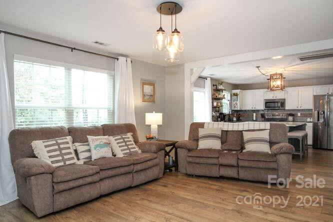 1431 River Run Road Lowell, NC 28098 - Photo 10 of 26 a living room with furniture and a large window