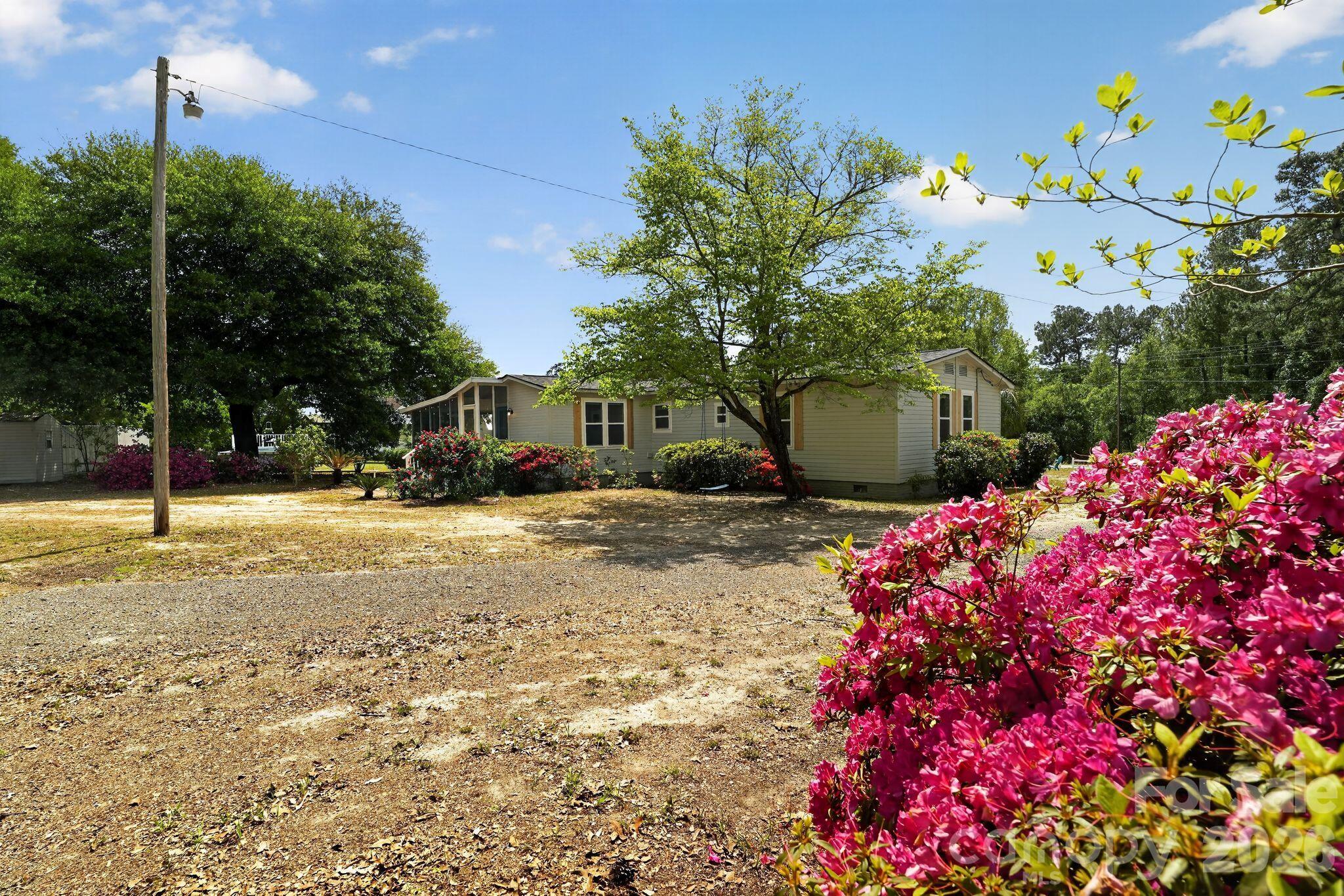 1724 Camp Shelor Road Manning, SC 29102 - Photo 29 of 48 a front view of a house with a yard and fountain
