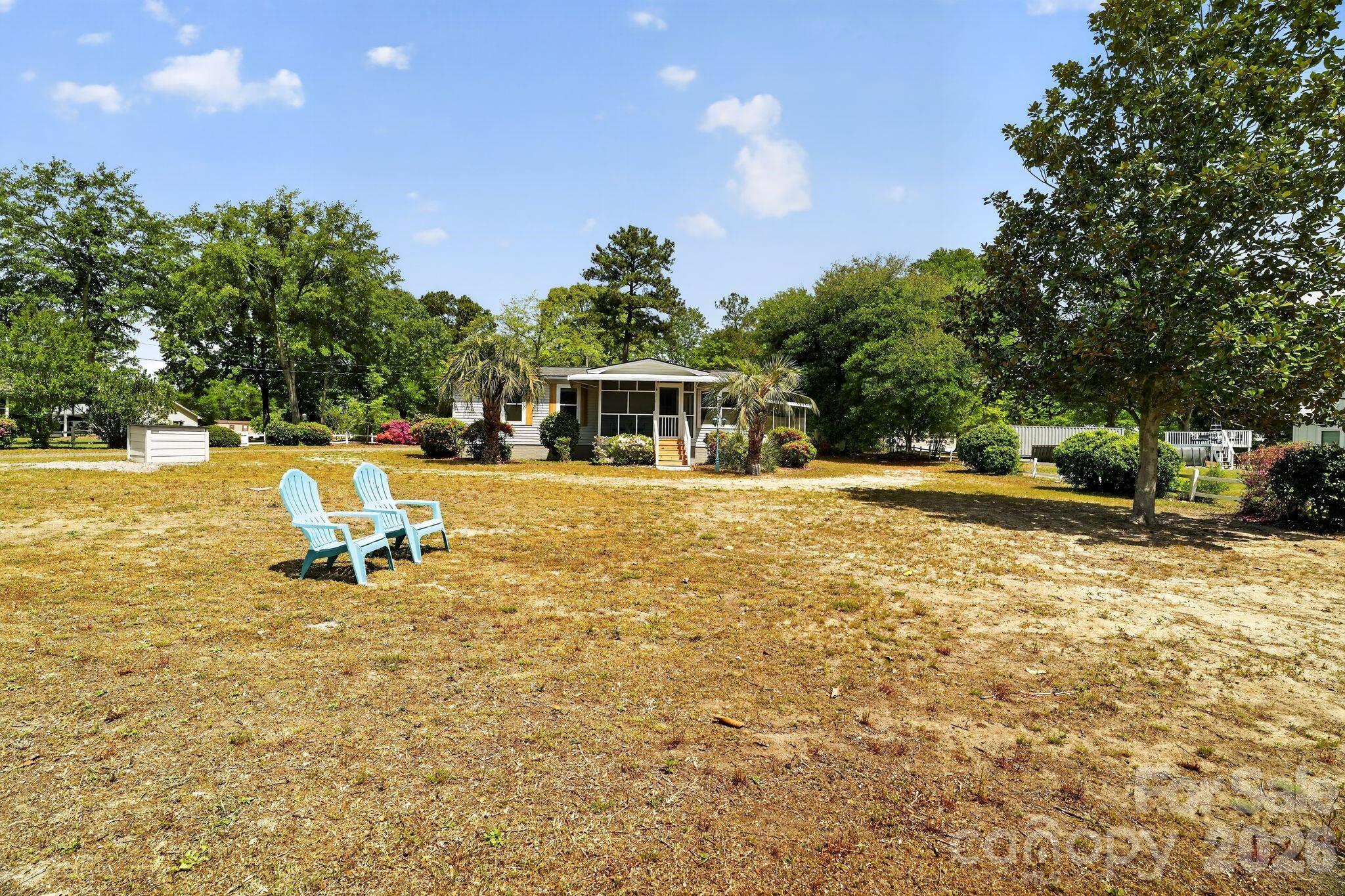 1724 Camp Shelor Road Manning, SC 29102 - Photo 31 of 48 a white house with a yard and sitting area