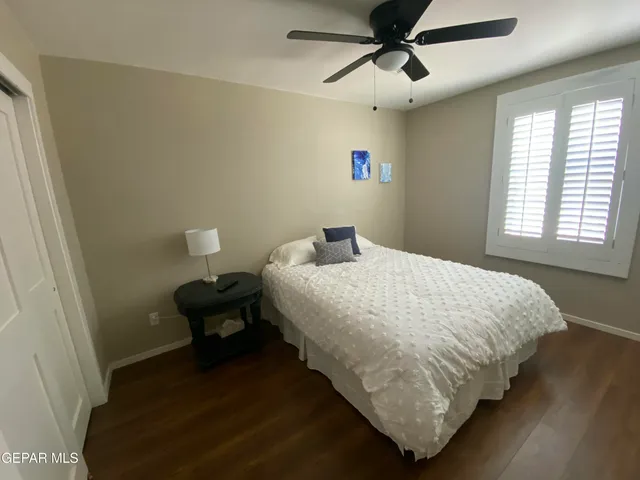 a bedroom with a bed and a ceiling fan