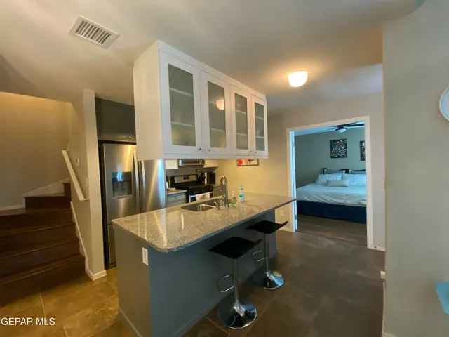 a bedroom with a bed and a mirror