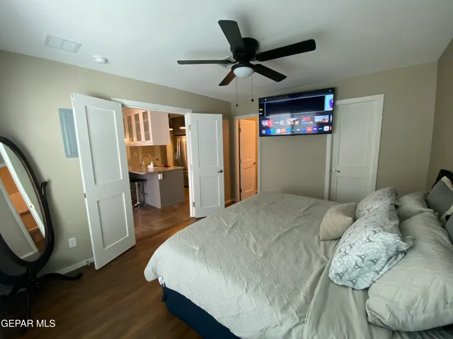 a bedroom with a bed and a large window